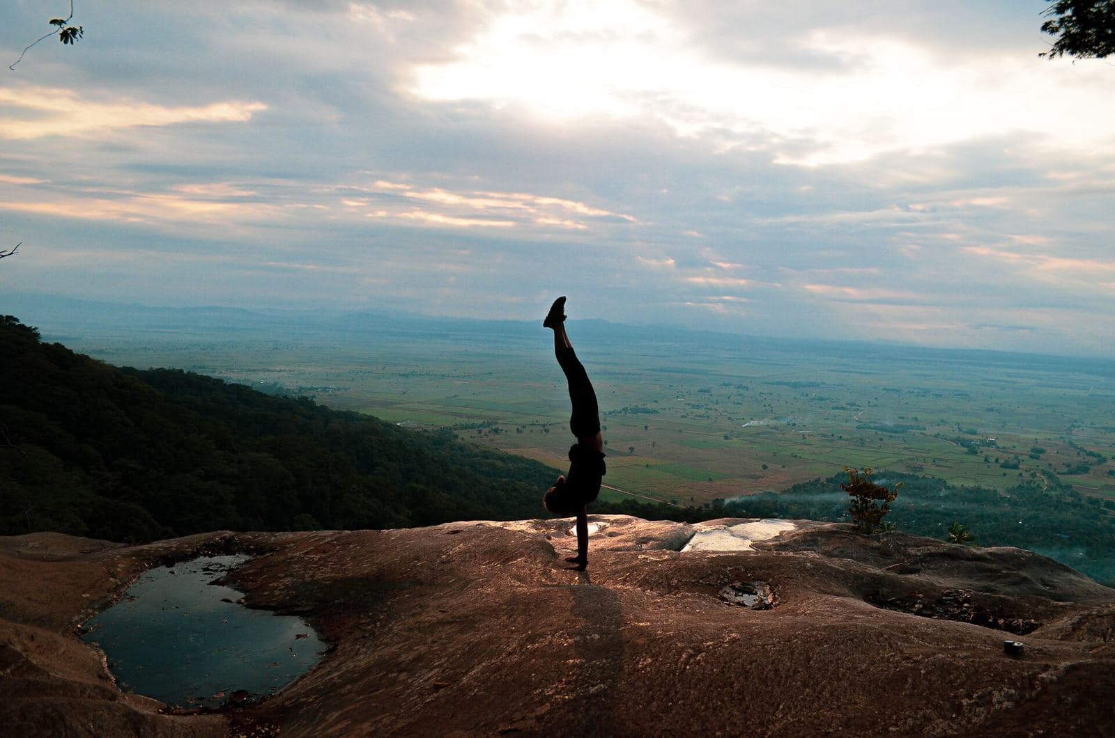 A hiker on a rock above the Kilombero valley in the Udzungwa Mountains